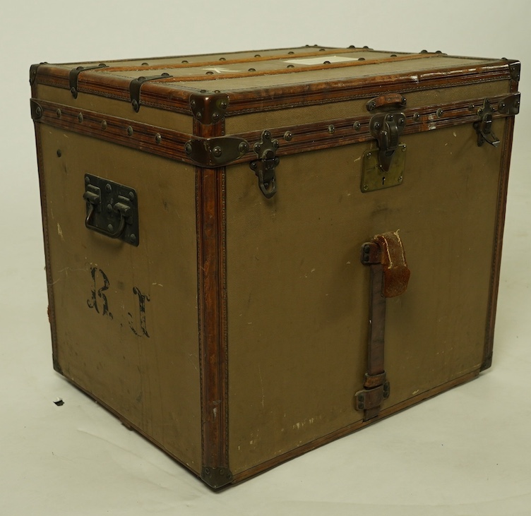 A vintage Louis Vuitton trunk, with brass and leather mounts and studded wooden slats, in plain beige canvas, with label for Paris and London, number 159008, 61cm wide, 48cm deep, 53cm high